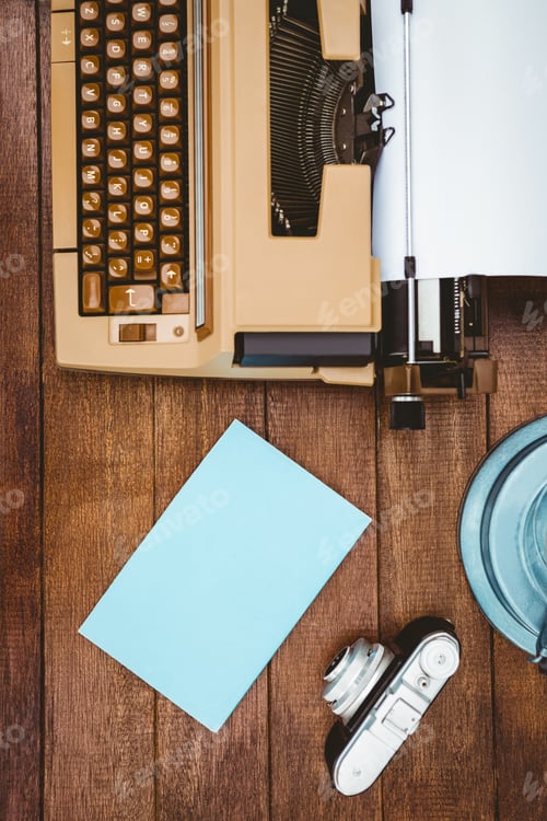 Preview: View of an old typewriter and camera on wood desk