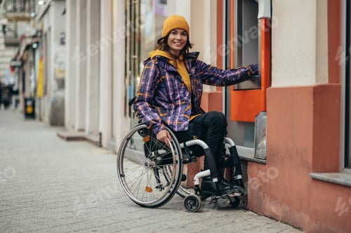 Preview: Woman with disability using credit card and atm machine