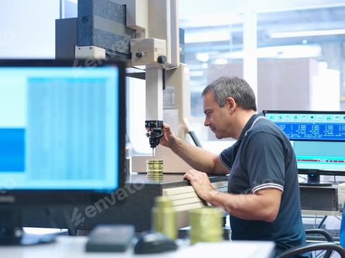 Preview: Male worker inspecting parts in engineering factory