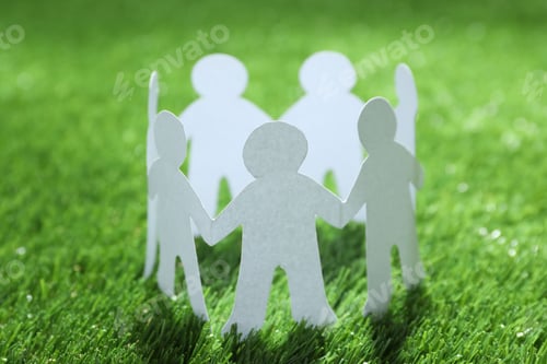 Preview: Paper people chain making circle on green grass. Unity concept