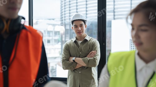 Preview: Portrait of supervisor engineers with hard hat while civil engineer and architect planning