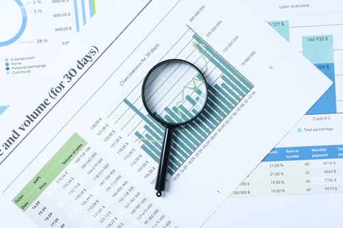 Preview: Magnifying glass and papers with diagrams, top view