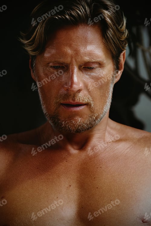 Preview: Caucasian mature male with mid-length hair looking down, pensive expression