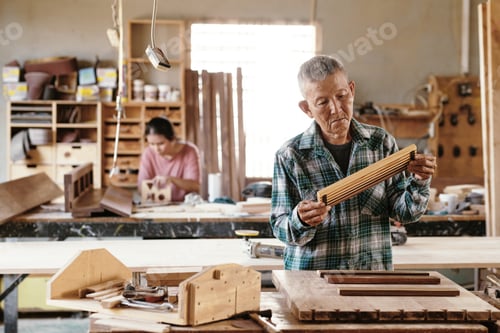 Preview: Experienced carpenter standing at workbenc