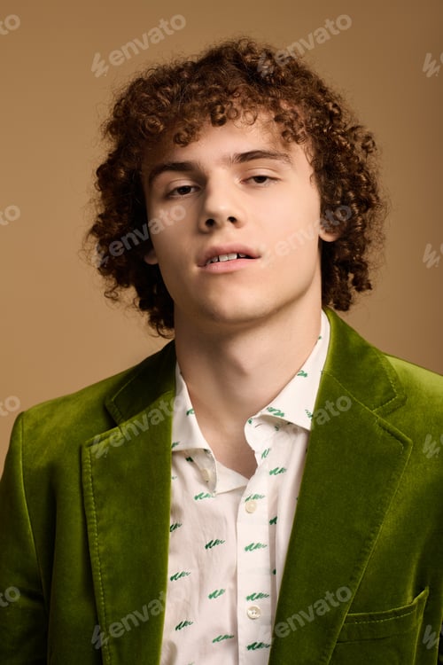 Preview: Curly-haired teenager showcases fashion in green velvet jacket during studio session
