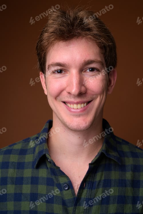Preview: Face of young handsome hipster man in green checkered shirt