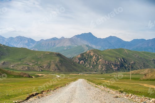 Preview: Dirt road through a wide mountain valley