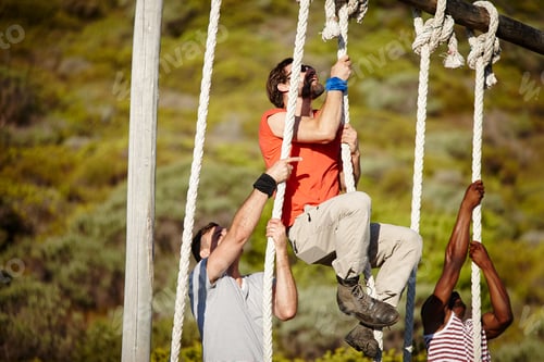 Preview: Shot of a group of men climbing up ropes at a military bootcamp