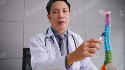 Preview: A male doctor explains the physiology of the human body via video call conference.