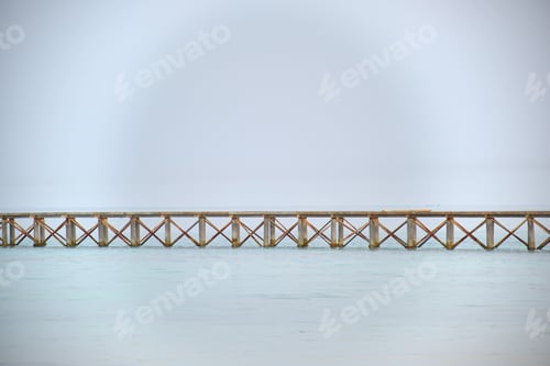 Preview: Long horizontal pier bridge on blue sky and water copyspace background