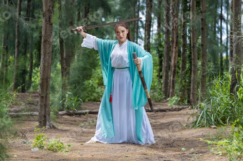 Preview: Young beautiful Asian woman dressed in ancient Chinese warrior style with ancient fan