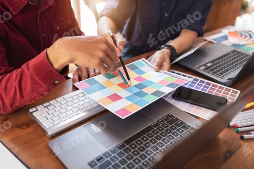 Preview: Asian colleagues designer drawing sketches on graphic laptop.