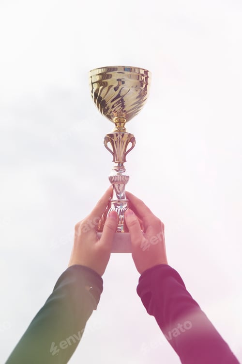 Preview: Woman holding gold trophy cup