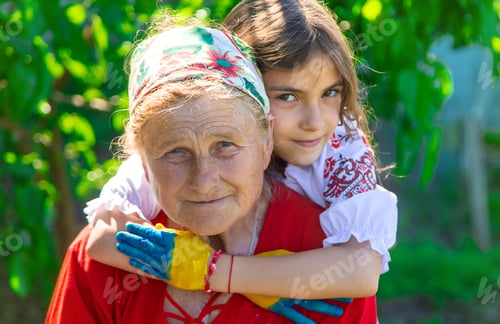 Preview: Child and grandmother hand drawn flag of Ukraine. Selective focus.