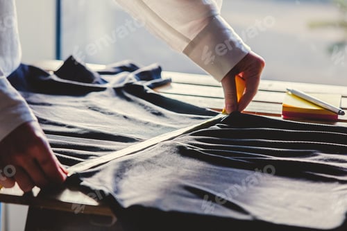 Preview: fashion designer hands with dress and measure tape