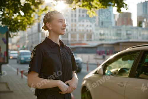 Preview: Closeup view of female patrol police officer standing on city street