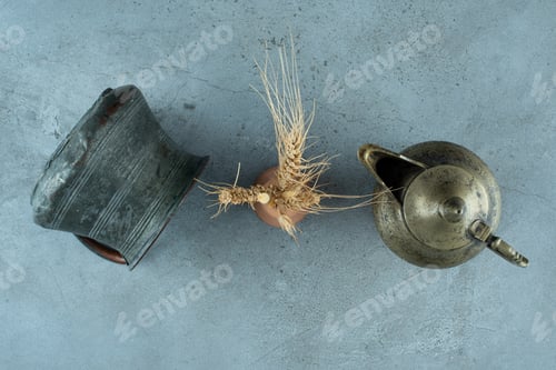 Preview: Wheat plant on a blue background with metallic pot and kettle around