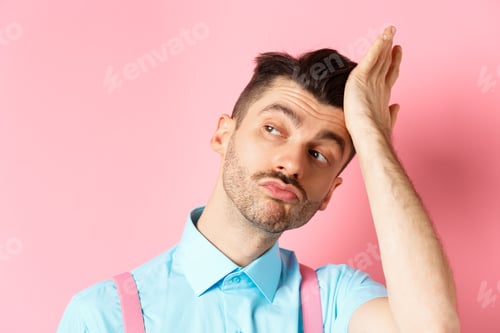 Preview: Close-up of handsome caucasian guy with moustache, feeling confident, touching his haircut and