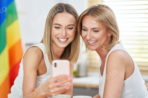 Preview: LGBT Lesbian couple love moments in the kitchen happiness concept