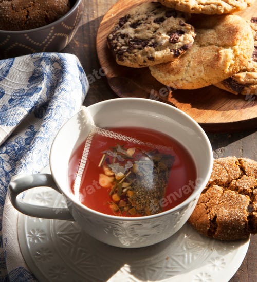 Preview: Close up of cup of tea with cookie
