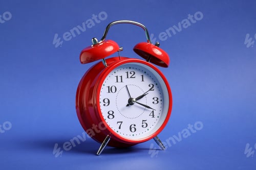 Preview: One red alarm clock on blue background