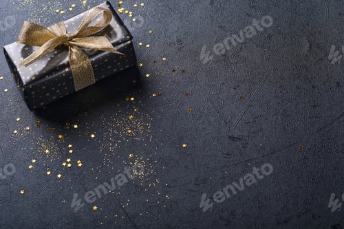 Preview: Elegant Black Gift with Gold Bow and Stars