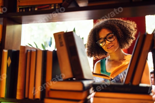 Preview: Happy African American female student studing in university library