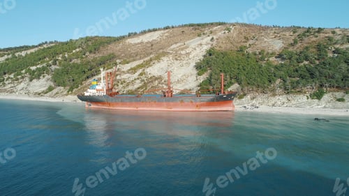 Preview: Large red tanker ship in the sea near the shore in clear blue water. Shot. Beautiful marine