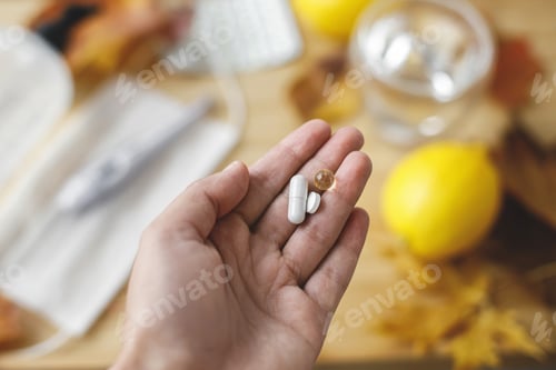 Preview: Boost immune system, coronavirus treatment. Hand with vitamin D, vitamin C and zinc pills