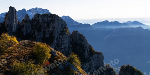 Preview: Beautiful landscape of the misty hazy Italian Alps mountain range during evening. Lombardy, Italy