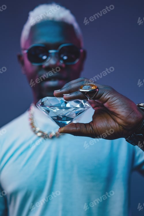 Preview: Rich african man with white hairs holding diamond