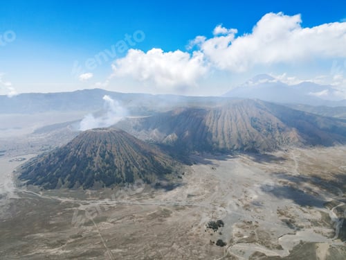 Preview: Aerial view of active volcano Mount Bromo, Indonesia with crater in depth. Brown dirt around.