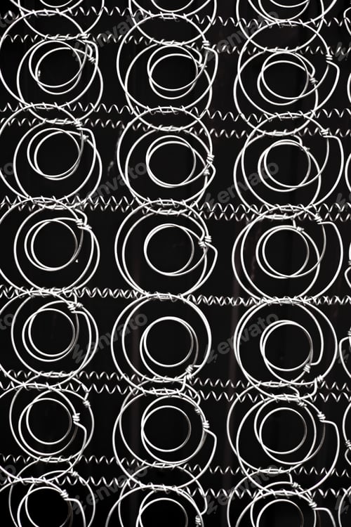 Preview: Block springs for mattresses isolated on black background.