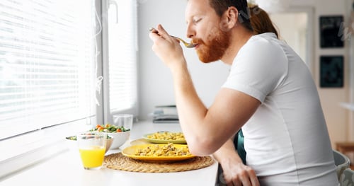 Preview: Couple having breakfast in the morning and smiling