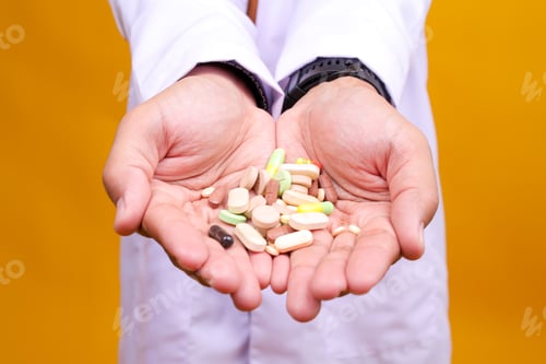 Preview: Close-up Male hands with Pills And drags Isolated On Yellow Background