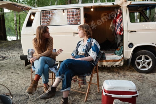 Preview: Hikers sitting outdoors during camping