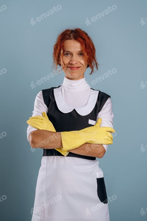 Preview: Hands in yellow gloves, maid is ready for work. Woman is in the studio against background