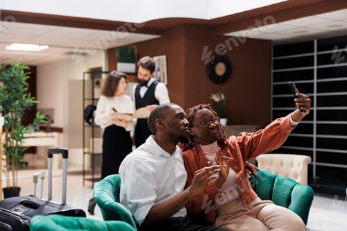 Preview: Cheerful guests taking pictures at hotel