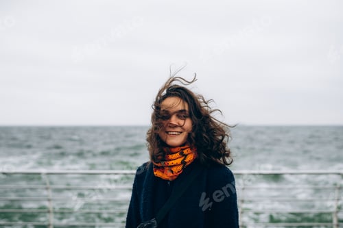 Preview: Portrait of happy smiling woman walking outdoor in the sea shore