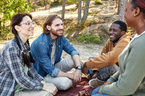 Preview: Happy friends having picnic outdoors