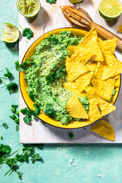 Preview: Nachos with green peas guacamole. Healthy vegetarian avocado alternative food