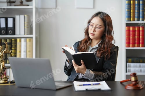 Preview: Lawyer is sitting at her desk in her office, surrounded by law books and a laptop