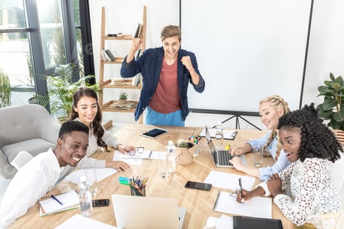 Preview: multicultural happy business team having conference at workplace in office