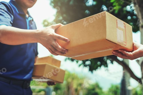 Preview: Delivery man delivering holding parcel box to customer