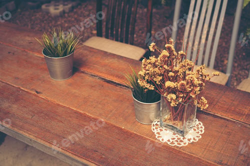 Preview: table in coffee shop with flower, vintage filter image
