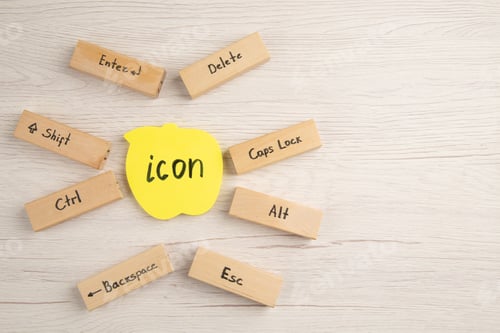Preview: top view keyboard icons on wood blocks icon written on yellow sticky note