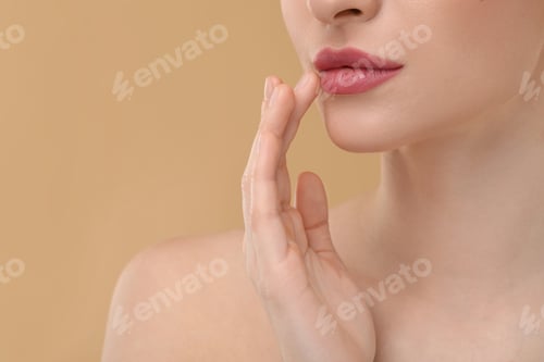 Preview: Young woman with beautiful full lips on beige background, closeup