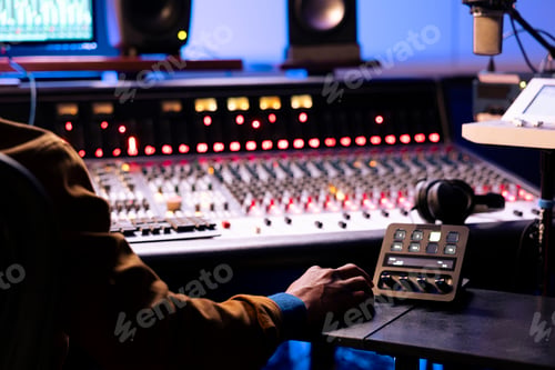 Preview: African american expert working at mixing panel in recording studio