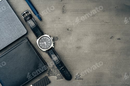 Preview: Businessman's accessories including notepad, watch and purse on dark grey background