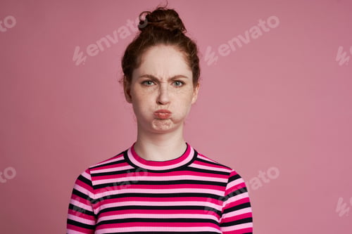 Preview: Studio shot of young woman with grimacing face